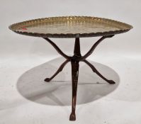 Large Middle Eastern brass engraved table top and wooden fold up base, 94cm diameter and another