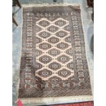 Persian style cream ground rug with two rows of five and one row of four hooked lozenges, multiple