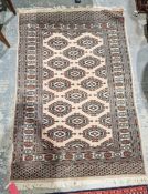 Persian style cream ground rug with two rows of five and one row of four hooked lozenges, multiple