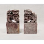 Pair of Chinese carved soapstone figures of dogs of fo, 20th century, on rectangular bases,