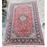 Central Persian red ground carpet with large central floral medallion on floral field, floral