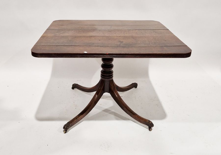 Late 19th/early 20th century oak tilt top table, raised upon four cabriole legs with brass Lion