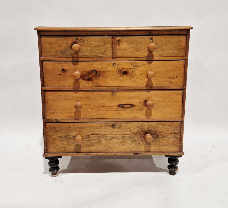 Stained pine chest of two short and three long drawers, on turned supports, 98cm high x 94cm wide