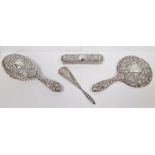 Three-piece silver-mounted dressing set comprising of two brushes and a mirror, repousse