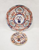 Large Asian porcelain Imari pattern charger decorated with vase to centre, floral baskets and