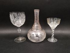 Mid 19th century engraved carafe and two wine glasses, the globular carafe engraved with stylised