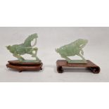 Two various carved jade horses, each with raised foreleg, 9cm high and the hardwood stands (some