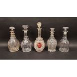 Five 19th century cut glass decanters and stoppers including a hobnail cut example with gilt