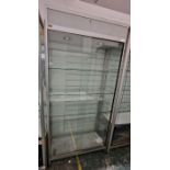 Two large glazed display cabinets each having glass sliding doors, one with four glass shelves,