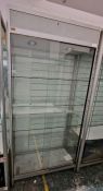 Two large glazed display cabinets each having glass sliding doors, one with four glass shelves,