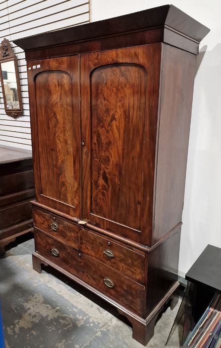 19th century mahogany linen press, the two-door cupboard opening to reveal three later shelves,