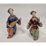 Pair of Japanese figures, seated female musicians, variously in red and blue robes, 26cm high