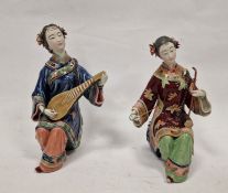 Pair of Japanese figures, seated female musicians, variously in red and blue robes, 26cm high