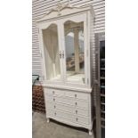 Modern white painted display cabinet chest, the two glazed doors raised over two short and three