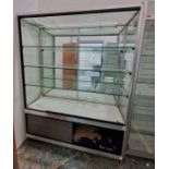 Large glazed display cabinet with mirrored back and three adjustable glass shelves, raised over a