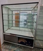 Large glazed display cabinet with mirrored back and three adjustable glass shelves, raised over a