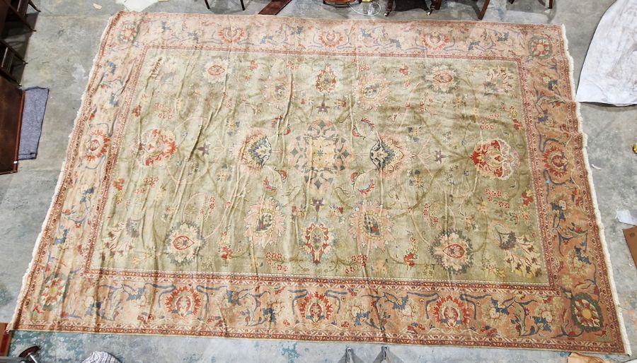 Very large pale green ground Turkish wool rug with central floral medallion on floral interlocked