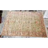 Very large pale green ground Turkish wool rug with central floral medallion on floral interlocked