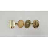 Pair of gentleman's 9ct gold cufflinks, of oval form, each cufflink set with a single red stone,
