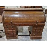 Early 20th century oak rolltop desk, the roll top opening to reveal a line of five drawers, each