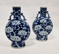 Pair Chinese porcelain moonflask vases, each with pair heart embossed handles and underglaze blue