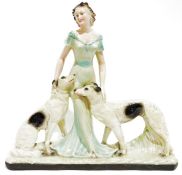 Art Deco painted plaster group of a woman in evening dress with two borzoi hounds, 55cm high