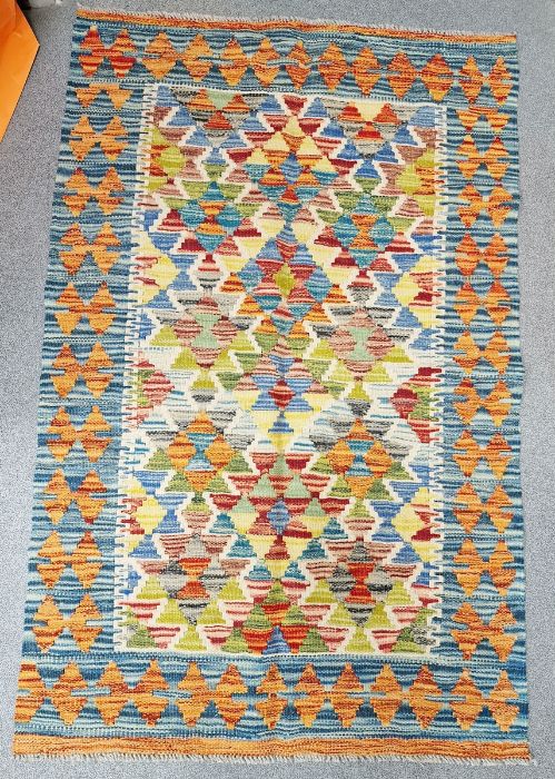 Cream ground Chobi kilim with geometric lozenge shape field, single geometric border, 126cm x 82cm