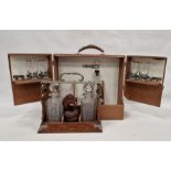 Vintage travelling/picnic drinks cabinet, an oak tantalus with two cut decanters and a stained