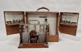 Vintage travelling/picnic drinks cabinet, an oak tantalus with two cut decanters and a stained