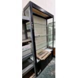 Large glazed display cabinet with three adjustable glass shelves, raised over a two-door sliding