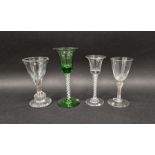 Four drinking glasses, two in the mid 18th century-style, the first with flared bowl and tear