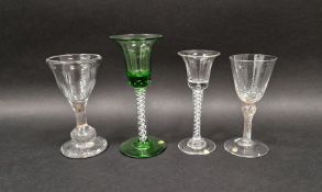 Four drinking glasses, two in the mid 18th century-style, the first with flared bowl and tear
