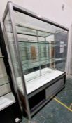 Large glazed display cabinet with two fitted glass shelves, raised over a two-door cupboard with