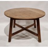 Early 20th century stained oak dining table of circular form, raised on a square tapering base