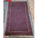 Eastern red ground carpet with geometric field, single geometric border, 305cm x 197cm (some wear)