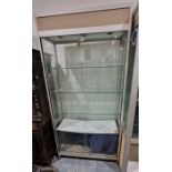 Large glazed display cabinet having three adjustable glass shelves and two glass sliding doors to