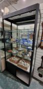 Large partially glazed display cabinet having three adjustable glass shelves, raised over a two-door