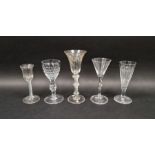 Group of five mid-18th and later drinking glasses, the first with flared bowl engraved with fruiting