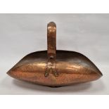 Arts & Crafts-style hammered copper trug with bar and strapwork handle, curved body
