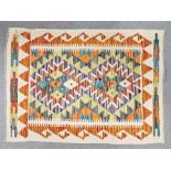 Cream ground Chobi kilim with two central stepped geometric medallions, single geometric borders ,