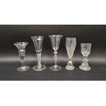 Group of five drinking glasses, comprising: an 18th century-style heavy baluster wine glass with