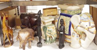 Carved hardwood model of a giraffe, a large ceramic model of an elephant and a smaller one, a carved