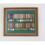 Collection of miniature gallantry medals and campaign medals within glazed frame.