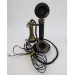 Early 20th century bakelite and brass candlestick telephone with the accompanying bell ringing