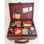 Canvas and leather carrying case containing various fishing accessories including salmon scales,