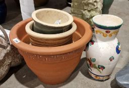 Terracotta plant pot, a pottery vase with painted floral decoration and further plant pots