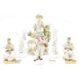 A late 18th century Derby candlestick figure of a putto, a pair of French porcelain figural