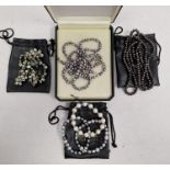Quantity of modern pearls to include three bracelets, long string of grey/black pearls and green
