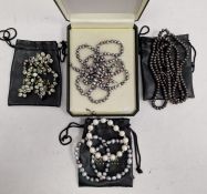 Quantity of modern pearls to include three bracelets, long string of grey/black pearls and green