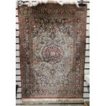 Persian style silk orange ground rug with central floral medallion on floral field and spandrels,